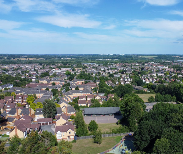 aerial view of residential area with houses and trees showcasing urban landscape and green spaces ideal for family living and community activities